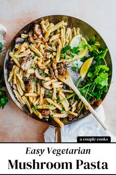 an easy vegetarian mushroom pasta recipe is shown in a skillet with lemon wedges and parsley