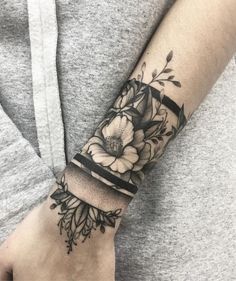 a woman's arm with flowers on it and the words love written in black ink