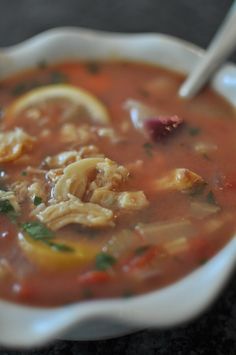 a white bowl filled with soup on top of a table