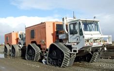 a large tractor is parked on the side of the road near some construction equipment and machinery