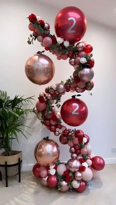 the balloon column is decorated with red, pink and white balloons that spell out number two