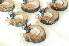 small wooden slices with blue flowers tied to them