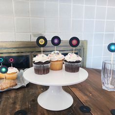 cupcakes are sitting on a cake stand