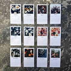 six calendars with flowers on them sitting on a counter top next to each other