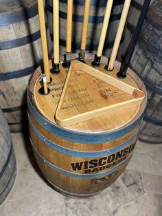 several wooden sticks sticking out of the top of a barrel