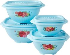 three blue bowls with roses painted on them and one bowl is sitting in front of the other