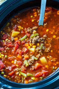 a crock pot filled with soup and vegetables