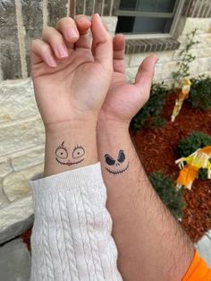 two people with matching tattoos on their wrist