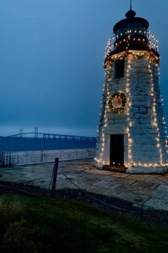 a light house is decorated with christmas lights