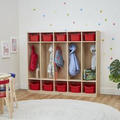 a child's playroom with several storage bins