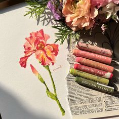 flowers and books are sitting on top of an open book