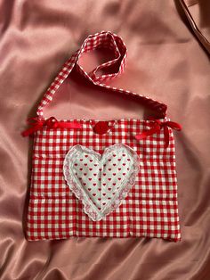 a red and white checkered bag with a heart on it