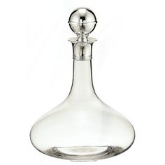 a clear glass bottle with a silver stopper on the top is shown in front of a white background