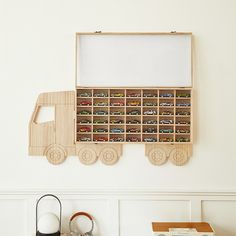 a wooden toy truck is mounted to the wall