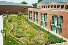 an aerial view of a building with many windows and plants growing on the side of it