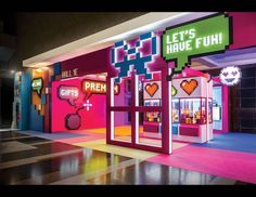 an image of a store front that is decorated with neon colors and pixel art on it