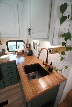 a kitchen with wooden counter tops and green cabinets