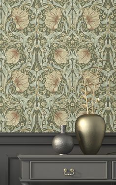 two vases are sitting on a dresser in front of a wallpapered background