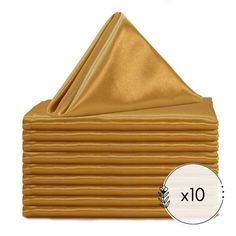 gold napkins are stacked on top of each other with the number 10 underneath them