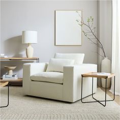 a living room with a white chair and table