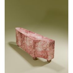 a pink marble bench sitting on top of a table