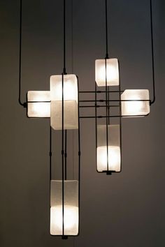 a chandelier with five square lights hanging from it's sides and four rectangular ones on each side