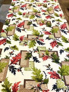 a table covered with a white and red floral design