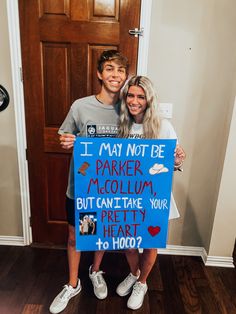 a man and woman holding a sign that says i may not be parker mccollum but can't take your pretty heart to hoo?