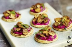 small appetizers with mushrooms and beet on a white platter next to silverware