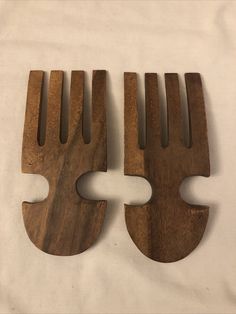 two pieces of wood that have been cut in half to look like forks and spoons