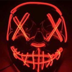 a neon mask that is glowing red and has the words x on it's face