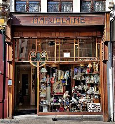 a store front with lots of items on display in it's windows and doors