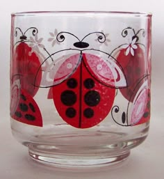 a glass cup with ladybugs painted on it