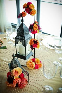 the centerpieces are decorated with candles, flowers and other decorative items for an elegant table setting