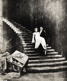 an old black and white photo of two women on stairs