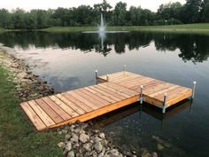 a wooden dock sitting in the middle of a lake