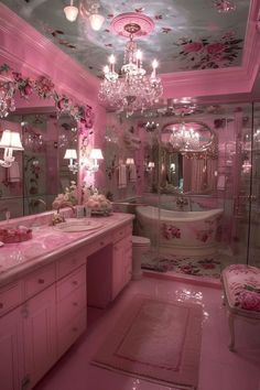 a pink bathroom with chandelier, sink and bathtub