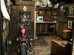 a motorcycle parked inside of a wooden building