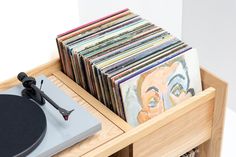 a record player is sitting next to an assortment of records