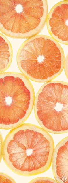 an orange is cut in half and placed on top of another grapefruit slice