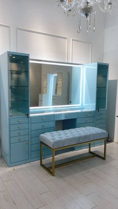 a blue bench sitting in front of a large mirror