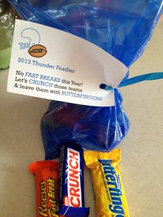 some candy bars wrapped in plastic and sitting on a counter top next to a blue bag