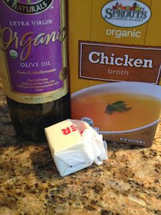 ingredients to make chicken broth sitting on a counter top next to a bottle of wine