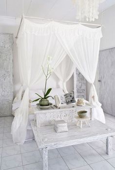 a white room with a bed and table