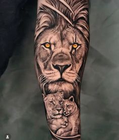 a lion and cub tattoo on the arm