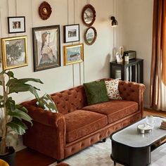 a living room filled with furniture and pictures on the wall