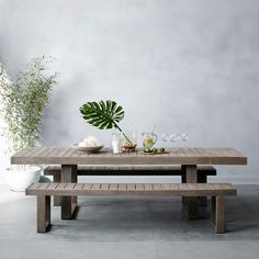 the table is made out of wood and has plants on it