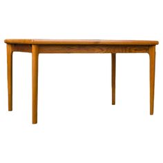 an oval wooden table with two legs and a long, narrow leg on one end