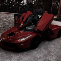 a red sports car with its doors open