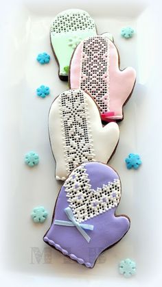 three decorated cookies are sitting on a plate